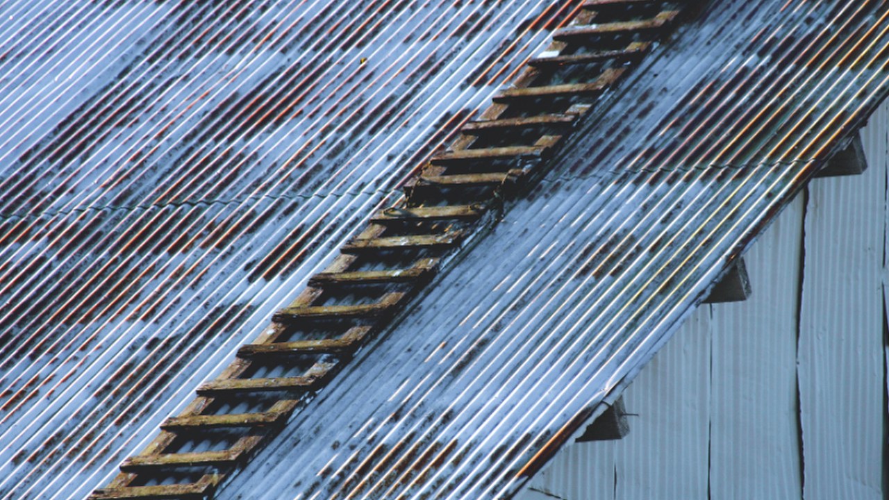 Roofer inspecting a property and documenting scope items.