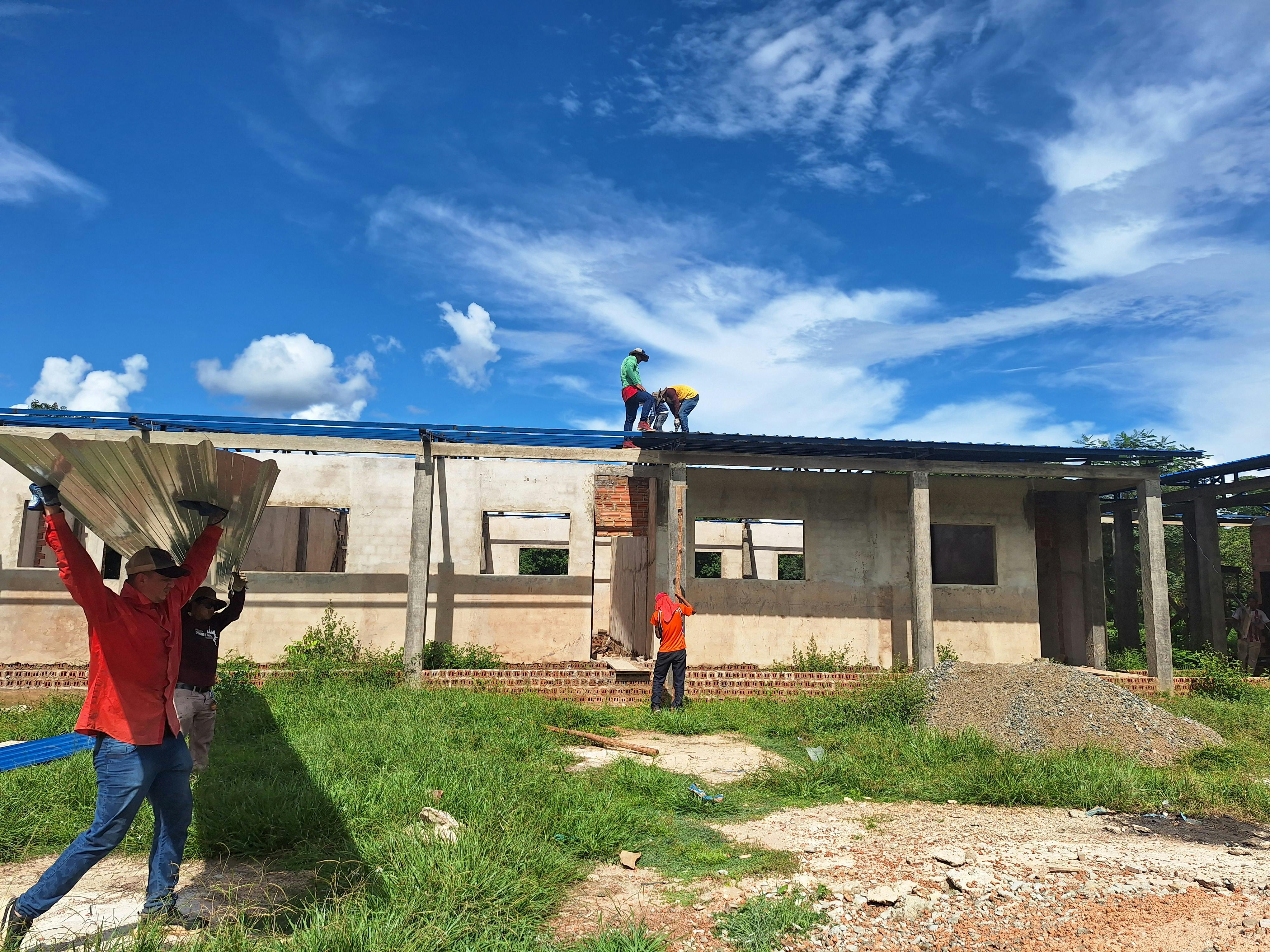 Roofing team inspecting and documenting field conditions.