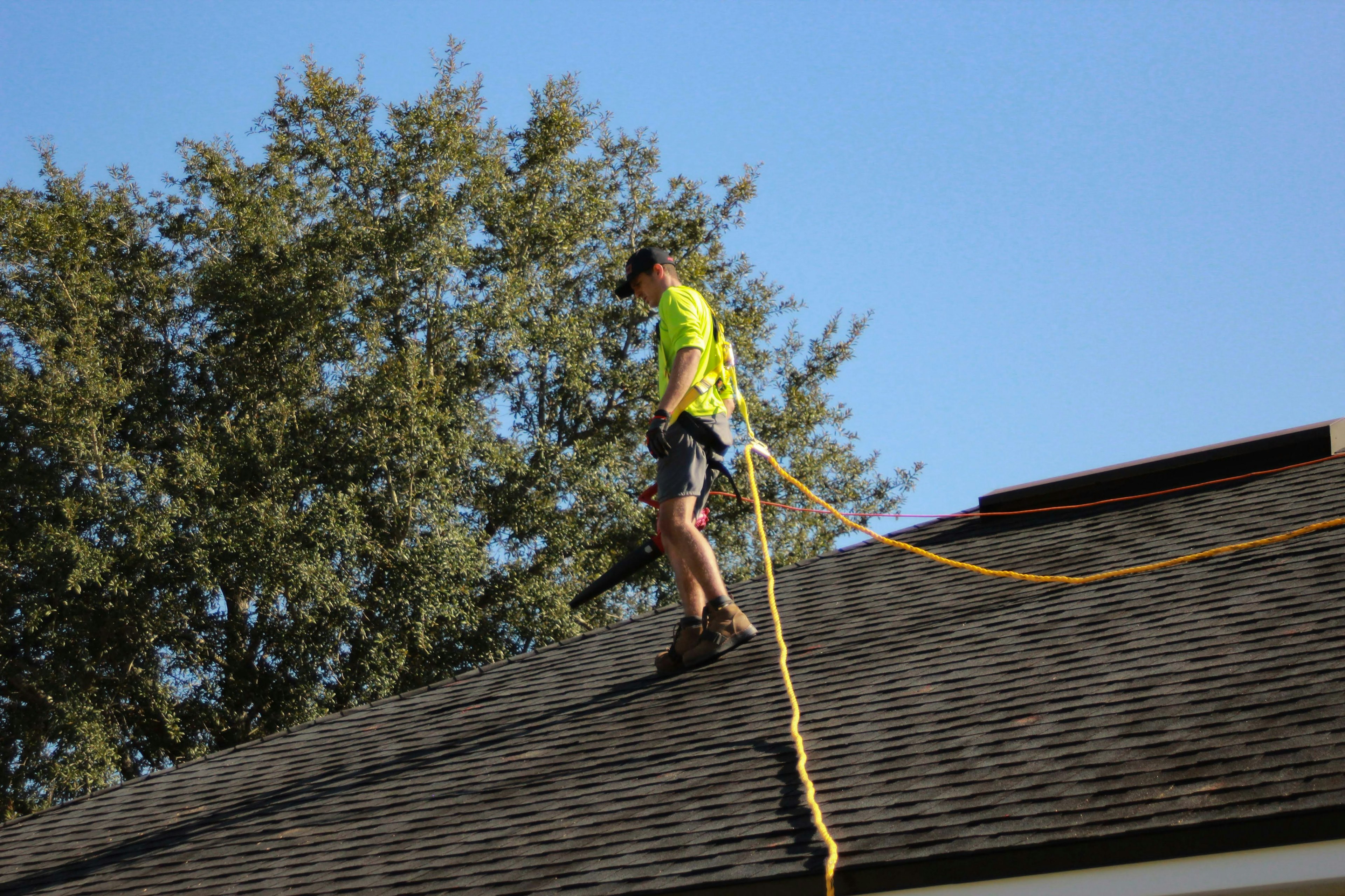 Roofer walking a roofline during scope alignment.